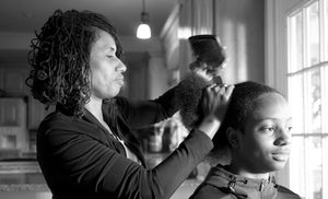 Melony Armstrong, Loctician, working on natural (black) African American hair.